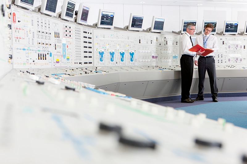 wide shot of two engineers with a file-discussing